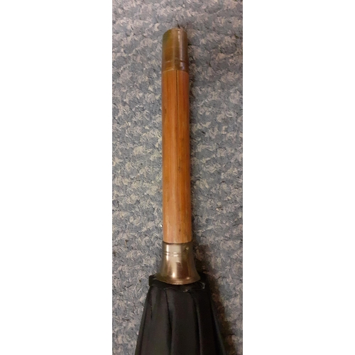 61 - A Vintage Briggs black umbrella, with incorporated racing pencil, engraved gold plated band, leather... 