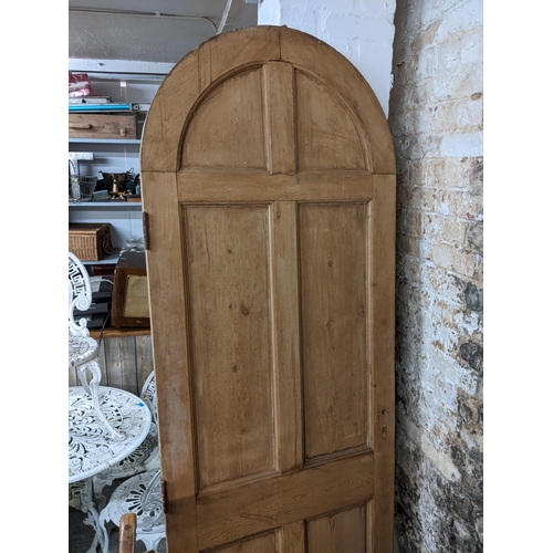 108 - A large Victorian pine, arched topped door inset with mirrored glass, 221h x 74.5w
Location: G