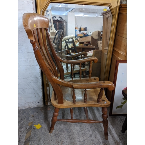 111 - A late 19th century elm seated lathe back chair having a pierced back and scrolled arms
Location: G