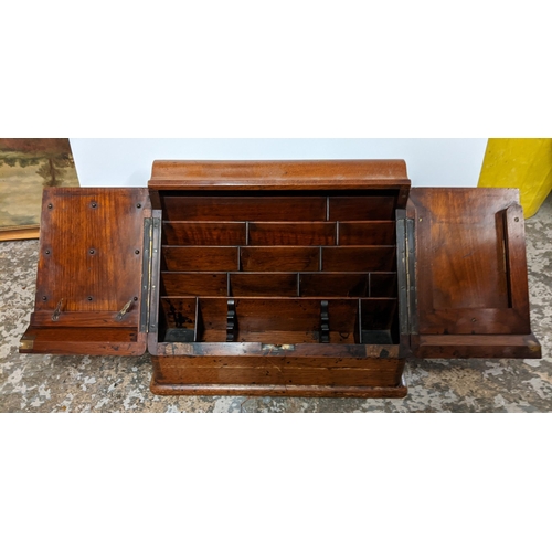 115 - A Victorian oak desk stand having two doors opening to reveal a fitted interior, together with Whiel... 