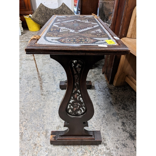 122 - A Victorian mahogany occasional table having a beadwork top with two lyre shaped pierced supports, 5... 