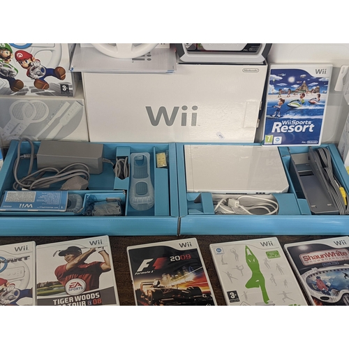 143 - A Nintendo Wii console and accessories to include 2 hand controllers with motion plus Nunchuk and ma... 