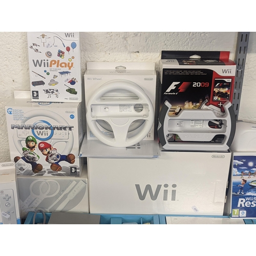 143 - A Nintendo Wii console and accessories to include 2 hand controllers with motion plus Nunchuk and ma... 