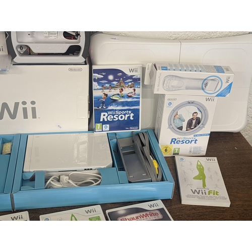 143 - A Nintendo Wii console and accessories to include 2 hand controllers with motion plus Nunchuk and ma... 