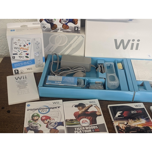 143 - A Nintendo Wii console and accessories to include 2 hand controllers with motion plus Nunchuk and ma... 