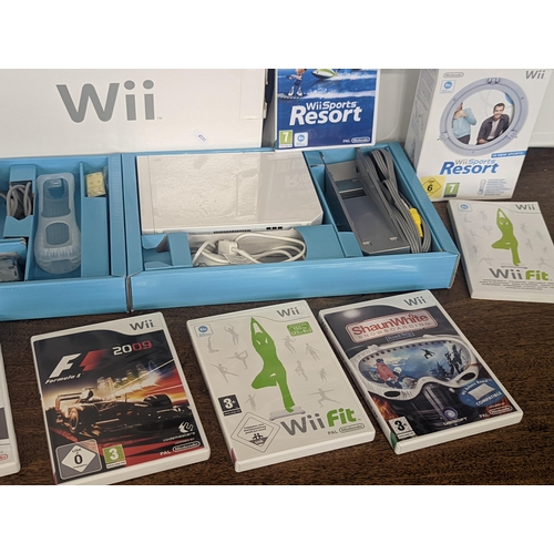 143 - A Nintendo Wii console and accessories to include 2 hand controllers with motion plus Nunchuk and ma... 