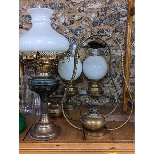 154 - A selection of oil lamps, together with a French style table lamp
Location: G