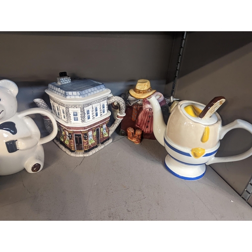 197 - A collection of novelty teapots to include Marmite, Coronation Street, Only Fools and Horses and oth... 