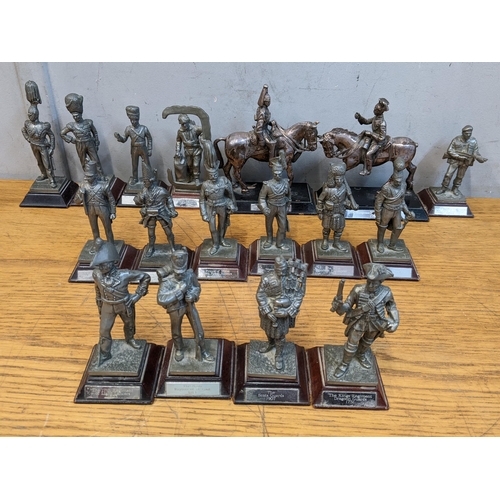 215 - Fifteen pewter model soldiers through the years and two silver plated military figures on horseback,... 