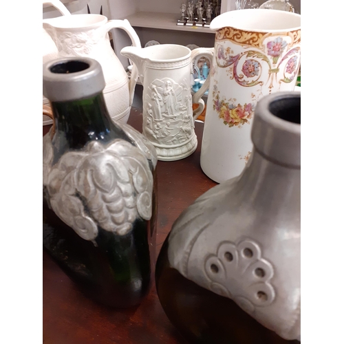 239 - A quantity of jugs and other items to include Wedgwood Meissen and Doulton and Parian style examples... 