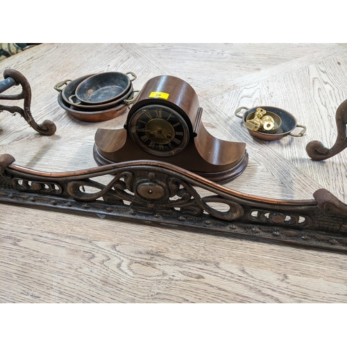 29 - An Art Nouveau cast iron fire curb, a walnut cased Napoleon style clock, copper and brass pans
Locat... 