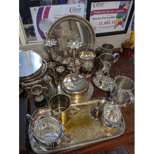 341 - A mixed lot of silver plate to include a caret jug, muffin dish, tankards, cutlery, teapot, trays an... 