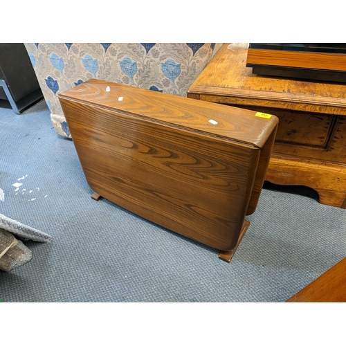 349 - A retro Ercol elm small fall flap table together with a telephone table and walnut occasional table
... 