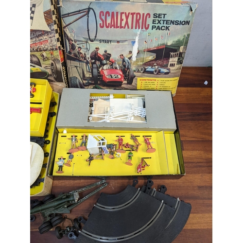 39 - A 1960s Scalextric comprising of Set 31 and Set extension pack with figures and cars, along with a d... 