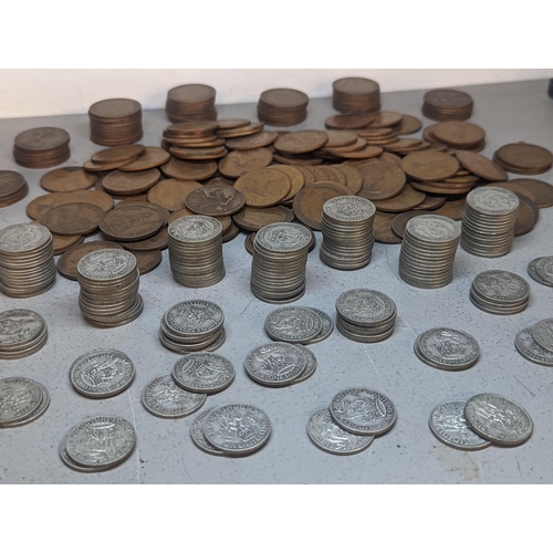 409 - A quantity of British shillings from 1920's to 1940's in various conditions, 832.7g together with a ... 