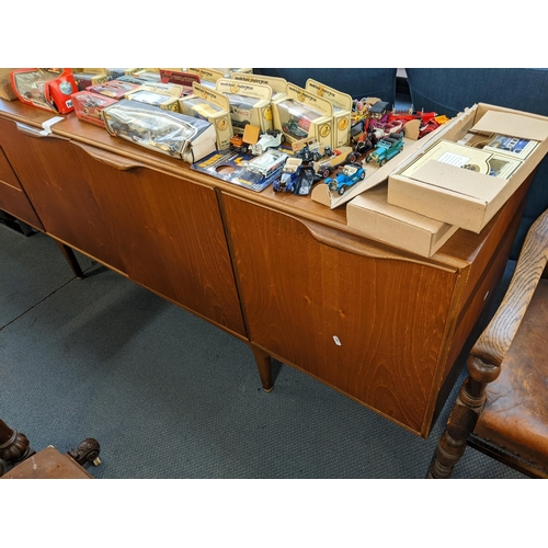 236 - A retro teak McIntosh sideboard having three drawers, two cupboard doors and a fall flap, 76cm h x 2... 