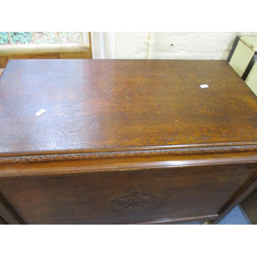 307 - A carved oak linen chest with hinged top on castors, and a mid-century teak foldover tea table with ... 