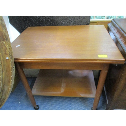 307 - A carved oak linen chest with hinged top on castors, and a mid-century teak foldover tea table with ... 