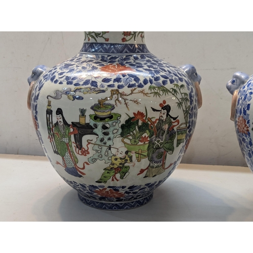 466 - A pair of 20th century Chinese vases decorated in polychrome enamels with figures in garden settings... 