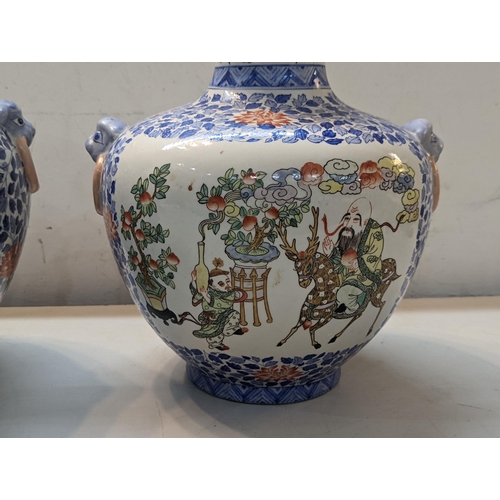 466 - A pair of 20th century Chinese vases decorated in polychrome enamels with figures in garden settings... 