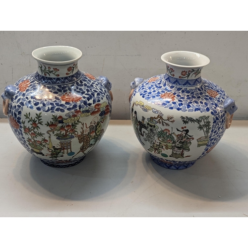 466 - A pair of 20th century Chinese vases decorated in polychrome enamels with figures in garden settings... 