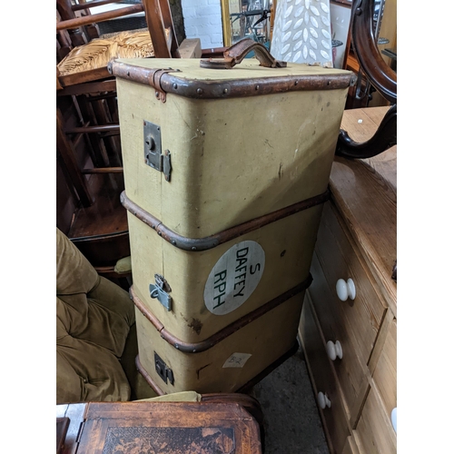 499 - A Victorian walnut button back armchair on turned legs, together with a vintage twin handled suitcas... 