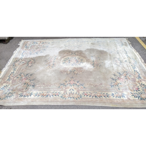 500 - A Chinese machine woven cream ground carpet having a floral design with a central motif, 370cm x 276... 