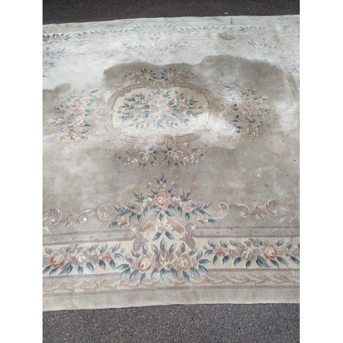 500 - A Chinese machine woven cream ground carpet having a floral design with a central motif, 370cm x 276... 