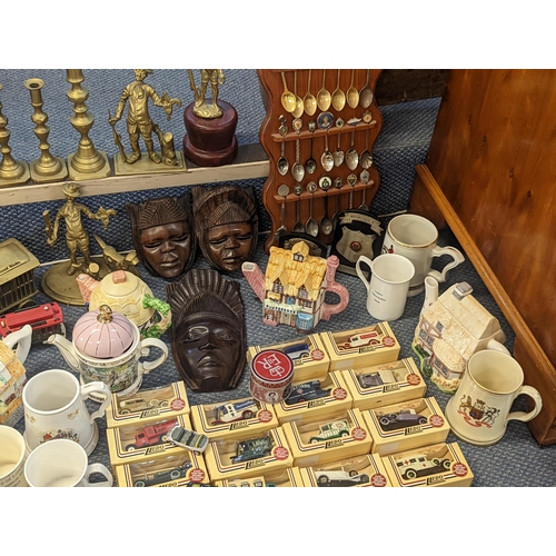 484 - A mixed lot to include collectors spoons, novelty teapots, trophies, mugs and diecast collectors veh... 