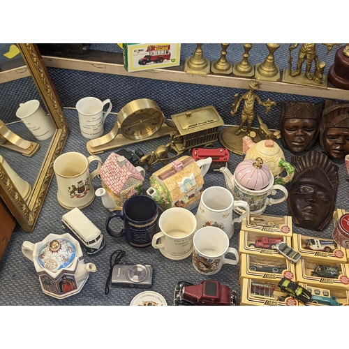 484 - A mixed lot to include collectors spoons, novelty teapots, trophies, mugs and diecast collectors veh... 