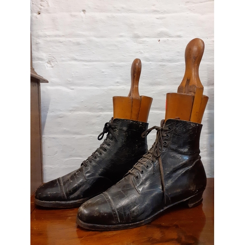 74 - A pair of Victorian ladies black leather boots together with a pair of vintage treen boot stays, sta... 