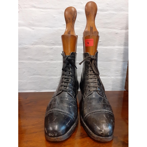 74 - A pair of Victorian ladies black leather boots together with a pair of vintage treen boot stays, sta... 