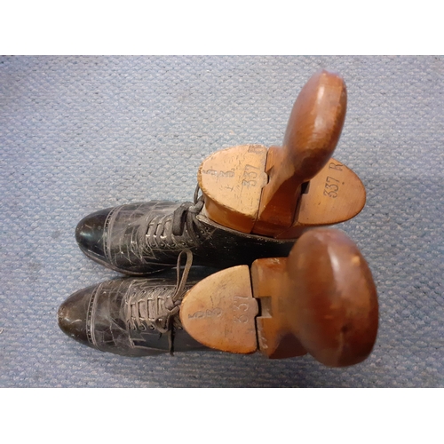 74 - A pair of Victorian ladies black leather boots together with a pair of vintage treen boot stays, sta... 