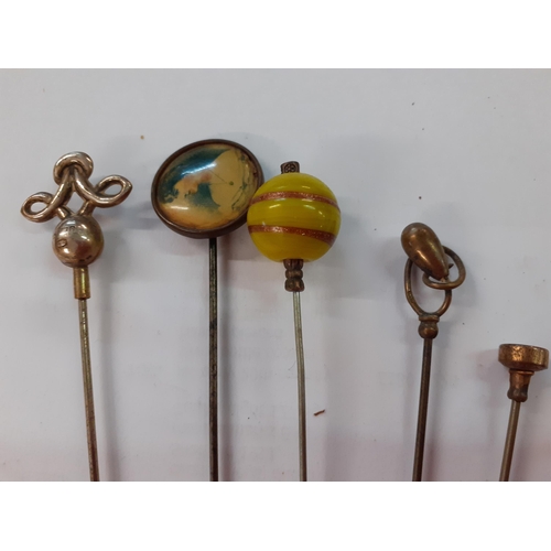 77 - A collection of decorative hat pins, mainly early to mid 20th Century, to include a blue enamelled e... 