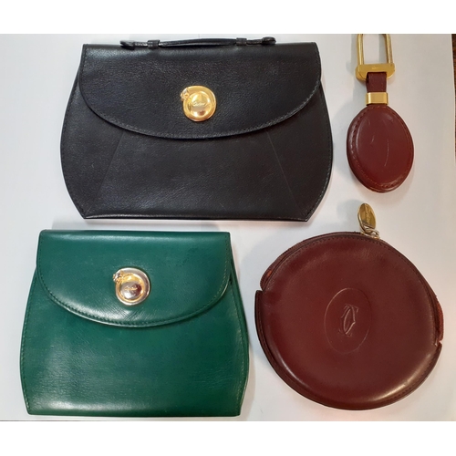 78 - Three vintage Cartier leather purses in green, black and burgundy together with a Cartier gold tone ... 