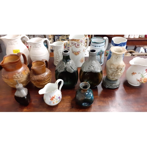 415 - A quantity of jugs and other items to include Wedgwood Meissen and Doulton and Parian style examples... 