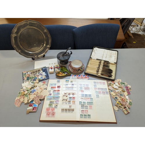 419 - A mixed lot of collectables to include a carved smoking pipe, stamps, silver plated platter and othe... 