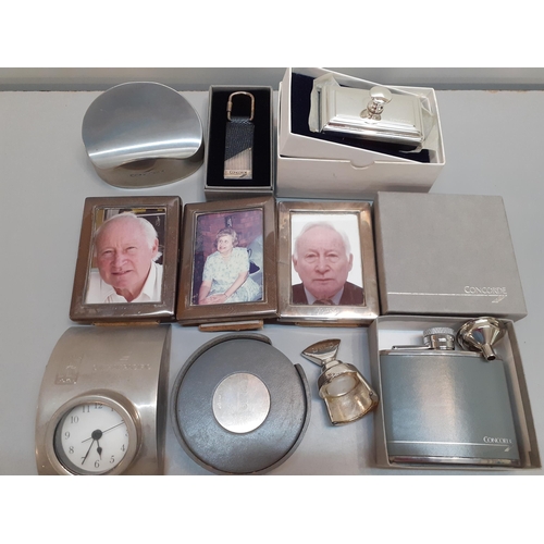 454 - Concorde related items comprising three small silver photo frames, coasters, a wine stopper, a key f... 