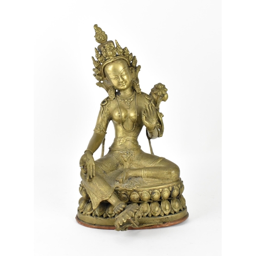 56 - A Sino-Tibetan bronze figure of the Buddha Green Tara, her left hand holding a lotus flower, while t... 