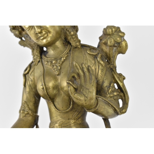 56 - A Sino-Tibetan bronze figure of the Buddha Green Tara, her left hand holding a lotus flower, while t... 