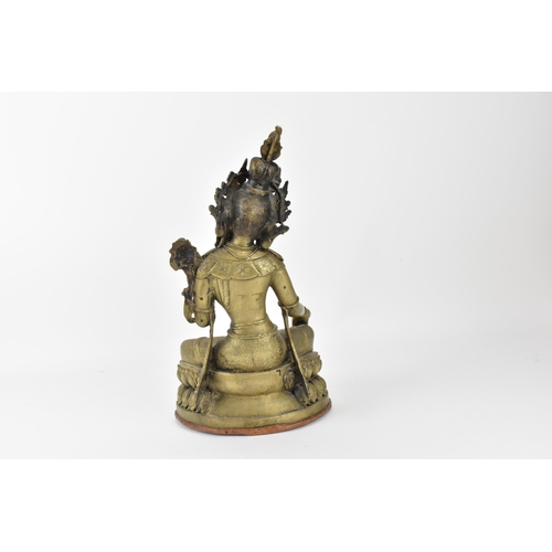 56 - A Sino-Tibetan bronze figure of the Buddha Green Tara, her left hand holding a lotus flower, while t... 