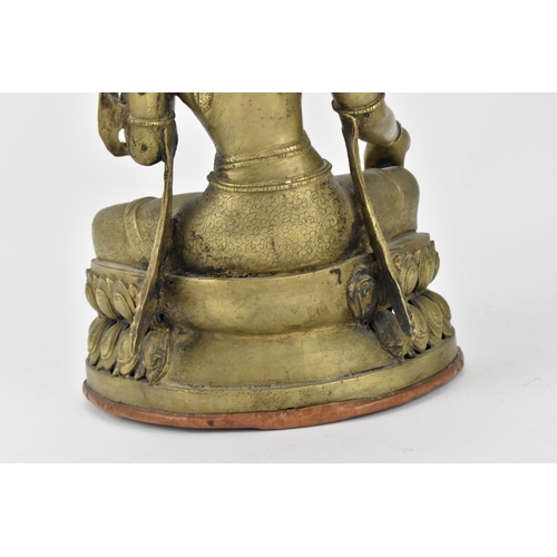 56 - A Sino-Tibetan bronze figure of the Buddha Green Tara, her left hand holding a lotus flower, while t... 