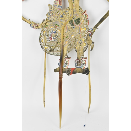 76 - Two late 19th/early 20th century Indonesian Wayang shadow puppets, to include one made of wood with ... 