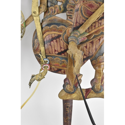 76 - Two late 19th/early 20th century Indonesian Wayang shadow puppets, to include one made of wood with ... 