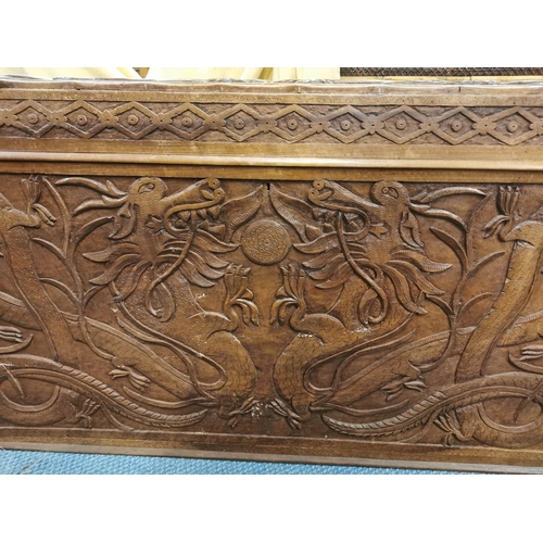 84 - An early 20th century Chinese camphor chest, with carved dragon design to the lid and sides, the fro... 