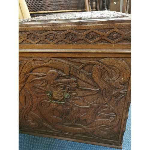 84 - An early 20th century Chinese camphor chest, with carved dragon design to the lid and sides, the fro... 