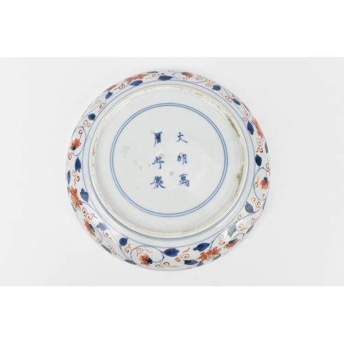 21 - A Chinese Qing dynasty Famille Verte porcelain dish, 18th century, of circular lobbed form with appl... 