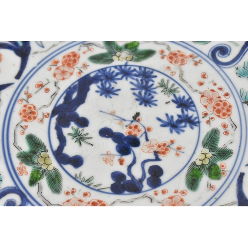 21 - A Chinese Qing dynasty Famille Verte porcelain dish, 18th century, of circular lobbed form with appl... 