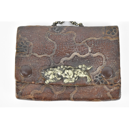 23 - A Japanese Meiji period tobacco sagemono (pouch) made from leather, with white metal foo dogs to the... 