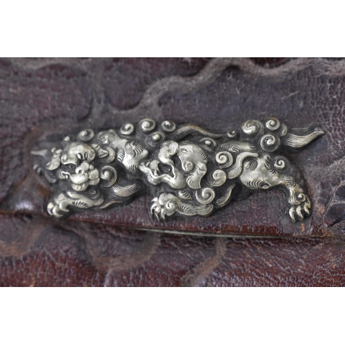 23 - A Japanese Meiji period tobacco sagemono (pouch) made from leather, with white metal foo dogs to the... 